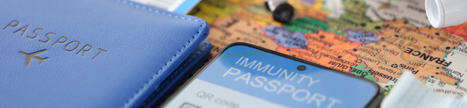smartphone-screen-certificate-immunity-against-covid-plane-ticket-passport-table
